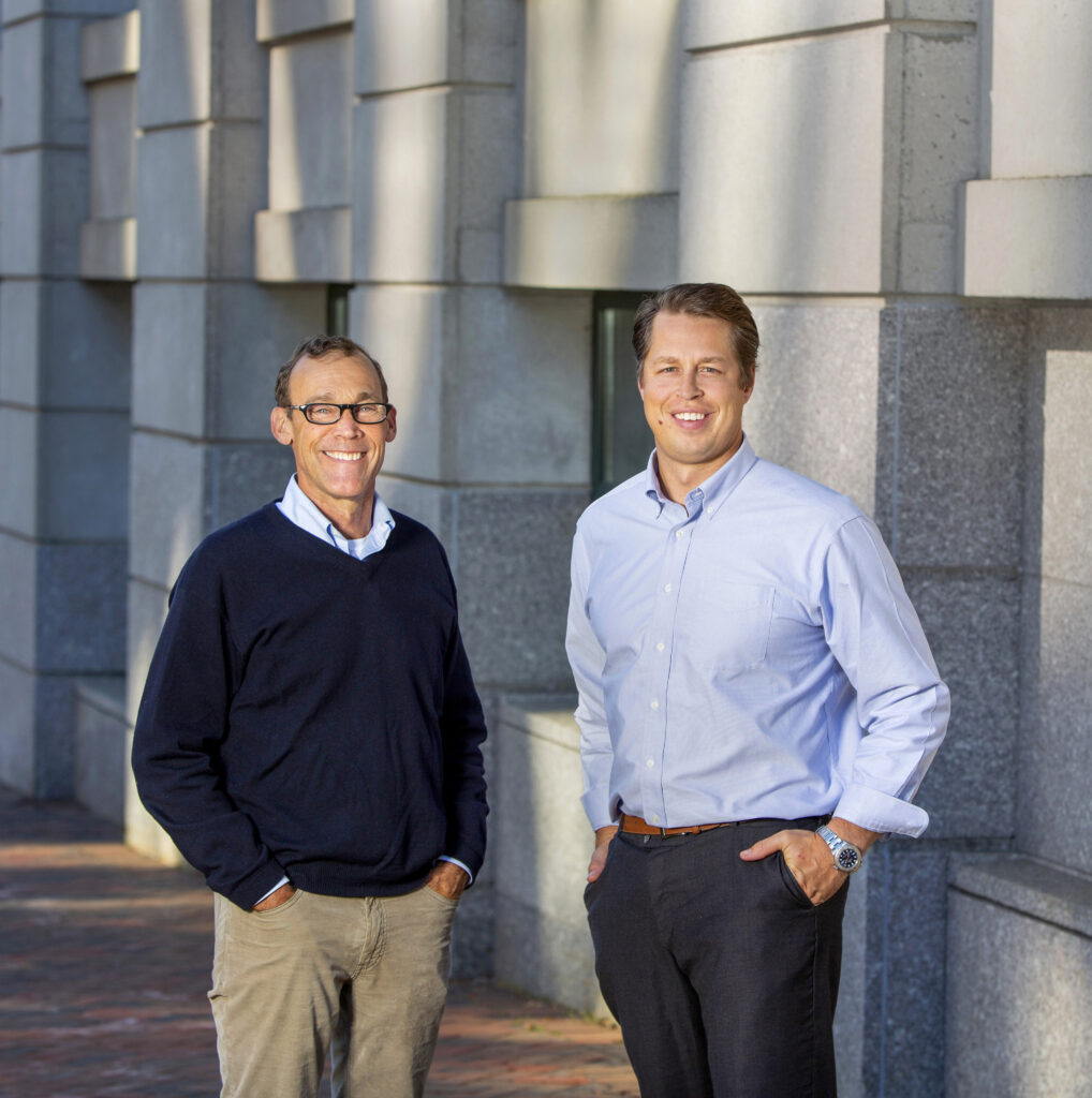 Two Dunham brokers stand by a building.