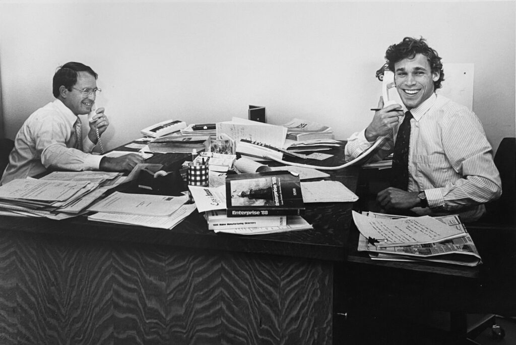 Old photo of two Dunham workers in an office