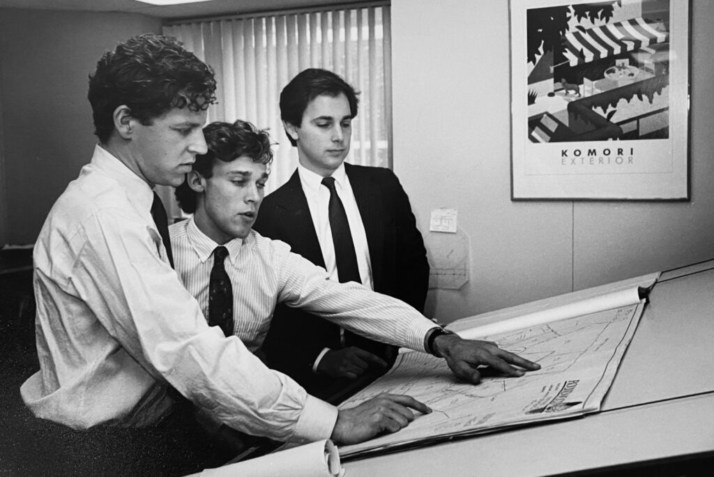 Old Photo of three Dunham workers planning